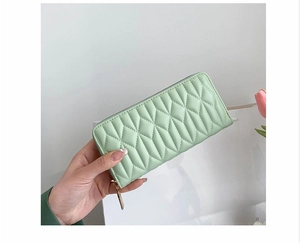 Detail of mint green quilted PU leather long clutch wallet with gold zipper for women