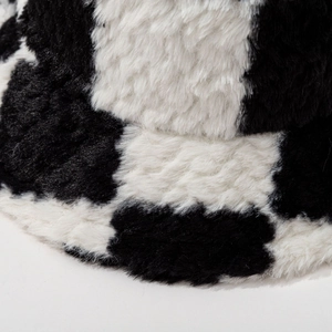 Checkered black and white faux fur bucket hat with thick plush texture and soft winter style