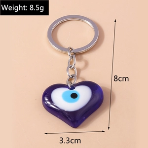 Detailed view of blue heart Evil Eye keychain with dimensions 8cm by 3.3cm and 8.5g weight