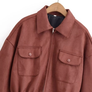 Detailed view of rust red faux suede jacket featuring lapel collar and large chest pockets