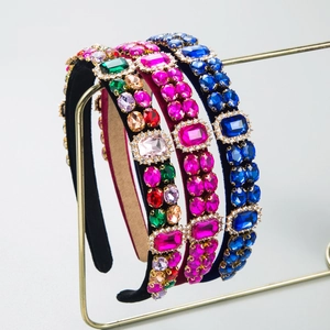 Luxury Baroque velvet headbands with colorful crystal embellishments on a gold stand