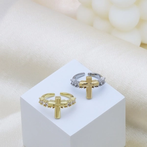 Adjustable two-tone cross ring with micro-paved crystals on white pedestal display