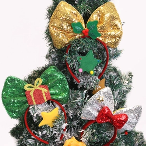 Three-piece Christmas headband set with festive bows and decorations on a snowy tree
