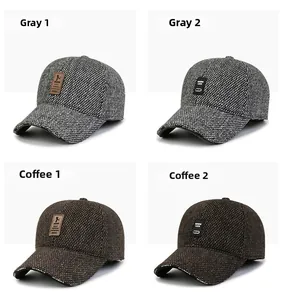 Detail of wool baseball caps in grey and brown with warm earflaps and textured knit finish