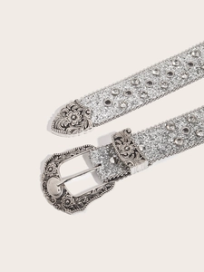 Detail of silver rhinestone belt with western floral engraved buckle and metallic sequins