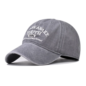 Detail of vintage washed cotton baseball cap featuring 3D white YOUTH letter embroidery