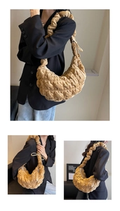 Close-up of khaki quilted cloud bag featuring pleated texture and crescent shape detail