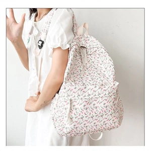 Japanese style floral canvas backpack for women shown from a side view on a model