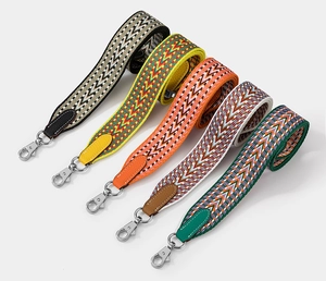 Detail of colorful woven shoulder straps with geometric patterns and silver metal hooks