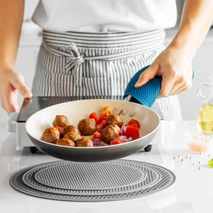 Extra large round grey silicone trivet and blue heat resistant gloves for kitchen