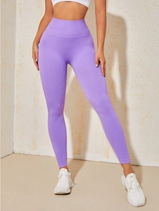 Close-up of seamless purple high-waisted yoga leggings showing tummy control waistband