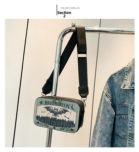 Detail of Halloween camera-style crossbody bag with bat prints and adjustable strap