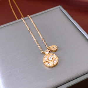 Detail of gold-plated circular necklace with star motif and cubic zirconia inlay