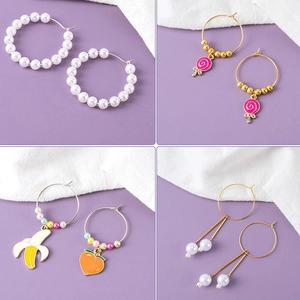 Assorted DIY hoop earrings featuring pearls, lollipop charms, and colorful fruit pendants