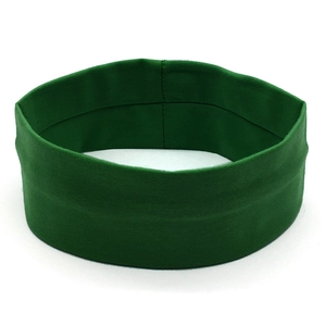 Close-up of dark green yoga headband showing elastic knit texture and reinforced stitching