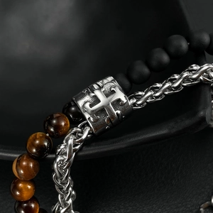 Detailed close-up of double-layer men's bracelet with tiger eye beads and silver cross charm
