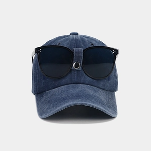 Close-up of a blue washed denim aviator baseball cap with integrated black sunglasses.