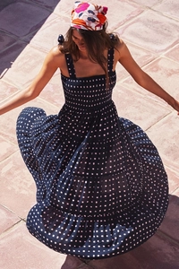 Detailed close-up of smocked bodice and tiered floral print on blue summer maxi dress