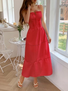 Detail of red vacation dress with spaghetti straps, tie-up bust and tiered skirt