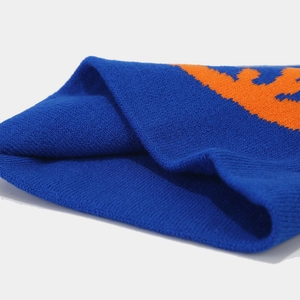 Detailed macro view of the jacquard knit fabric pattern and tight weave on the blue beanie