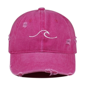 Detailed view of the rose pink distressed baseball cap with white wave embroidery