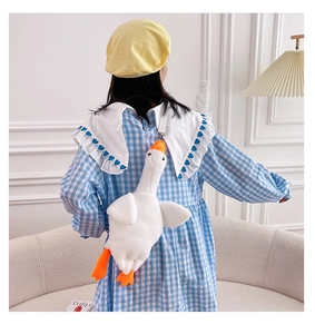 Rear view of a soft white goose plush crossbody bag worn with a casual outfit