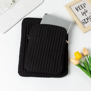 Black quilted laptop sleeve set and tablet inner case for minimalist office workspace
