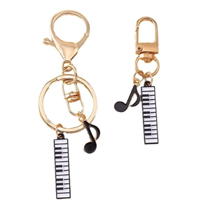 Golden music theme keychains with piano keys and musical notes on white background