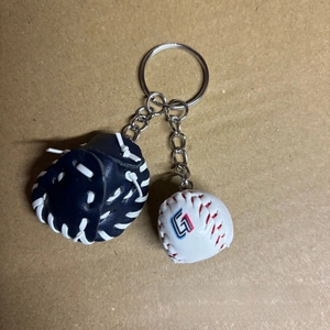 Detail view of mini leather baseball glove and ball keychain on silver metal ring