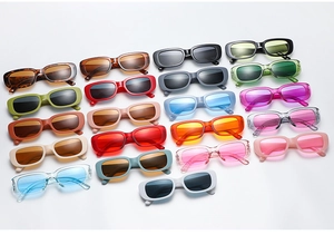 Multiple colorful vintage rectangular sunglasses in vibrant candy colors displayed together