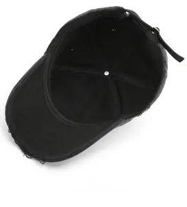 Detail view of the black baseball cap showing the interior stitching and adjustable metal strap
