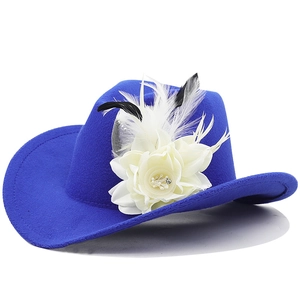 Close-up of vibrant blue wool felt cowboy hat with cream flower and feather accents