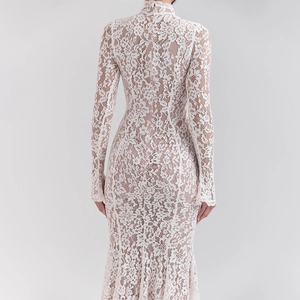 Close-up back view of a white lace long sleeve dress featuring an elegant fishtail hemline