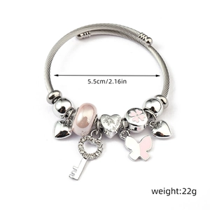 Detail of silver beaded bracelet featuring pink charms and heart pendants with dimensions