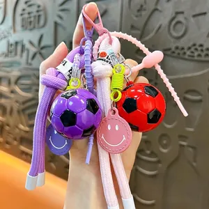 Soccer ball keychain pendants in red and purple with woven rope and smiley charm