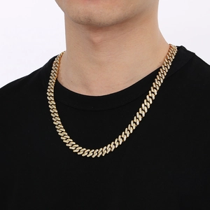 Close-up of a gold-toned iced-out Cuban link chain featuring intricate diamond-set detailing