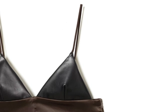 Detail of black faux leather and brown satin patchwork top with fine thin straps
