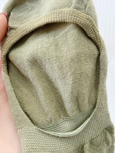Close-up of light green low-cut invisible sock showing fabric texture and edge detail