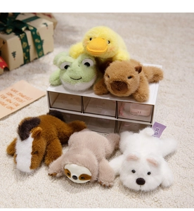 Detailed view of plush animal magnets featuring capybara, sloth, and duck on soft rug