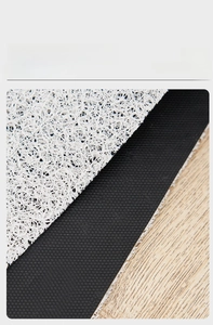 Detail of PVC silk loop mat showing the non-slip black textured bottom and beige surface