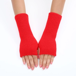 Close-up of red striped knitted fingerless gloves worn by a model on white background