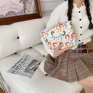 Quilted cotton vanity bag with colorful flower pattern shown in a lifestyle setting