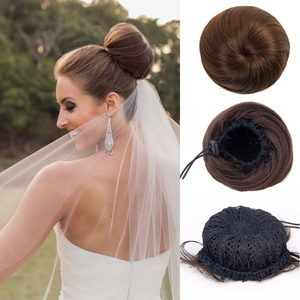 Macro detail of brown drawstring hair bun extension with mesh base and secure clips