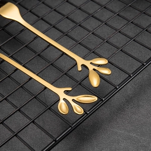 Set of 2 golden stainless steel spoons with creative leaf handle design for dessert and coffee