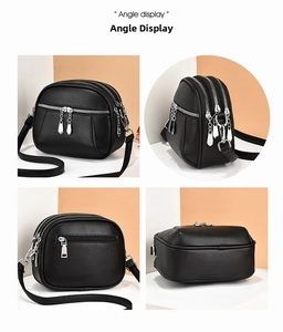 Detail view of black PU leather crossbody bag showing multi-layer zipper compartments