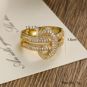 Detailed view of intertwined 18K gold plated copper ring with sparkling white zircons