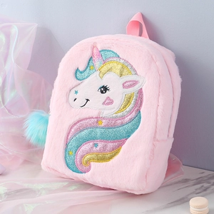 Detail of embroidered unicorn pattern with rainbow sequins on pink plush backpack