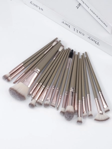 Macro view of 20-piece makeup brush set with rose gold ferrules and soft gradient bristles