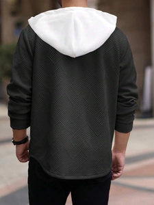 Rear view of olive green hoodie showing geometric jacquard texture and contrast white hood