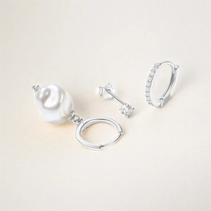 Detail of S925 sterling silver earring set with baroque pearl and cubic zirconia studs